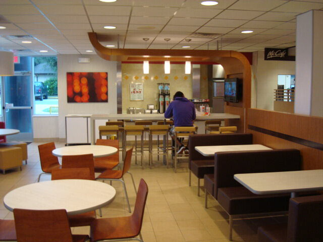 McDonalds finished interior with patron at counter seating