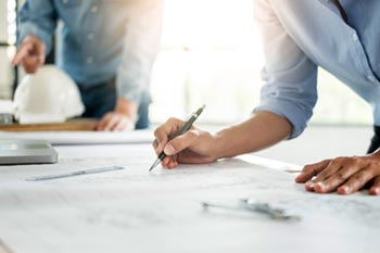 Construction workers reviewing bluprint